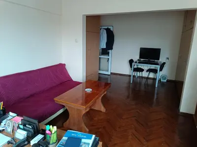 a living room with a couch and a table at Апартамента на центъра на Варна до фонтаните in Varna City