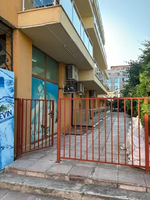 a building with an orange gate in front of a building at Cozy studio in Sunny beach in Sunny Beach