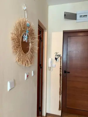 a room with a door and a wreath on the wall at Cozy studio in Sunny beach in Sunny Beach
