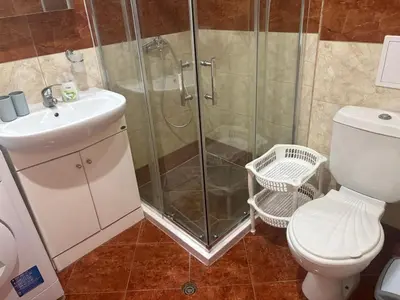 a bathroom with a shower and a toilet and a sink at Amartmán přímo u moře - Elenite in Sveti Vlas
