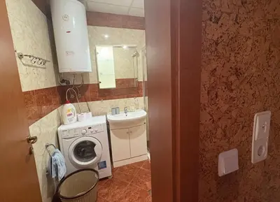 a bathroom with a washing machine and a sink at Amartmán přímo u moře - Elenite in Sveti Vlas