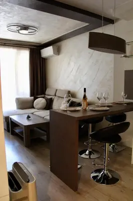 a living room with a couch and a table with wine glasses at Cozy by the Sea in Burgas City