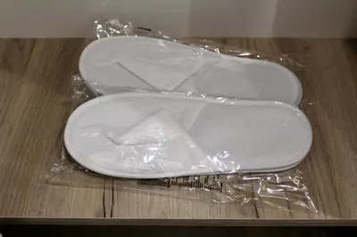 a pair of white shoes wrapped in plastic on a table at Cozy by the Sea in Burgas City