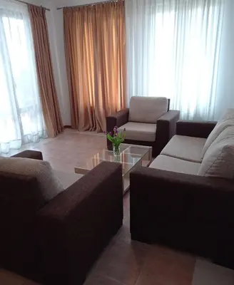 a living room with two couches and a coffee table at Апартаменти за гости Морска гледка in Chernomorets