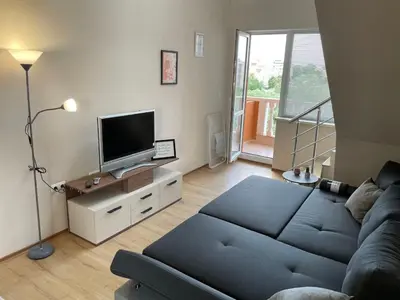 a living room with a couch and a flat screen tv at Sea Diamond 2 in Sunny Beach