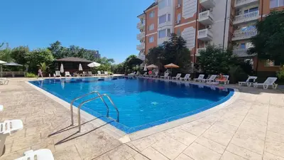 a large blue swimming pool in a building at Sea Diamond 2 in Sunny Beach