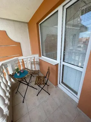 a balcony with two chairs and a table and a window at Sea Diamond 2 in Sunny Beach