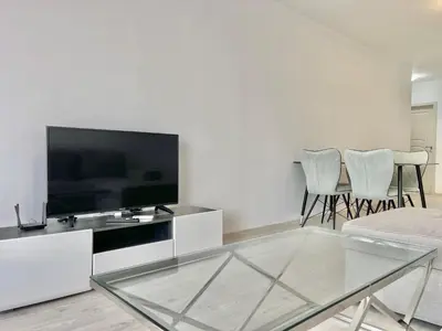 a living room with a tv and a glass table at Millennium 2 - Private apartment - BSR in Sveti Vlas