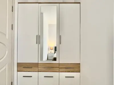 a white cabinet with a mirror in a room at Millennium 2 - Private apartment - BSR in Sveti Vlas