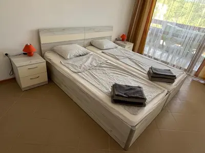 a bedroom with a bed with two towels on it at Apartamenty na Zielonych Wzgórzach in Sunny Beach