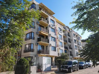 an apartment building with cars parked in front of it at 2 Zimmer Wohnung in Sunny Beach in Sunny Beach