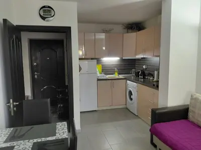 a small kitchen with a purple couch in a room at 2 Zimmer Wohnung in Sunny Beach in Sunny Beach