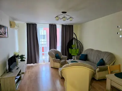 a living room with two couches and a tv at The Sea Balcony - 1BD Apartment by Flat Mаnager in Burgas City