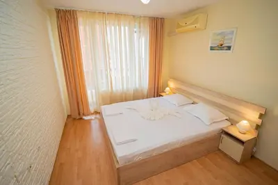 a bedroom with a white bed and a window at The Sea Balcony - 1BD Apartment by Flat Mаnager in Burgas City