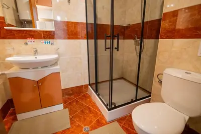 a bathroom with a shower and a toilet and a sink at The Sea Balcony - 1BD Apartment by Flat Mаnager in Burgas City