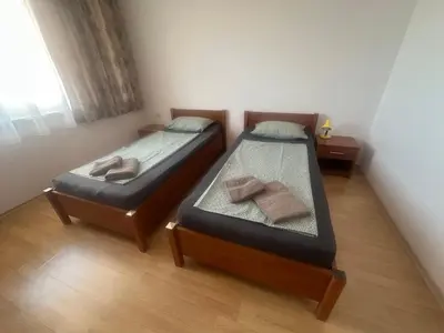 two twin beds in a room with a window at Amartmán přímo u moře - Elenite až 5 osob in Sveti Vlas