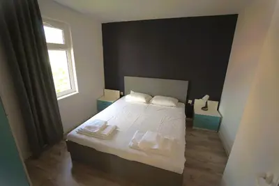 a bedroom with a bed with towels on it at Emona 5 floor 4 in Burgas City