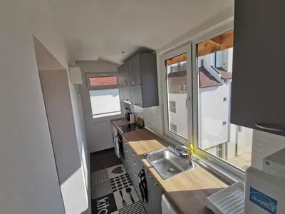 a small kitchen with a sink and a window at Emona 5 floor 4 in Burgas City