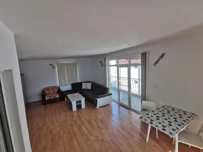 a living room with a couch and a table at Emona 5 floor 4 in Burgas City
