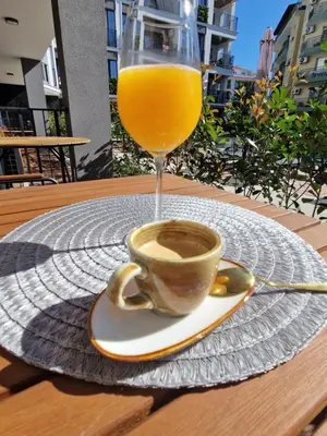 a cup of coffee and a glass of orange juice at NEU 2025 Emila Romana Boutique- Modernes Luxury Living in Sunny Beach