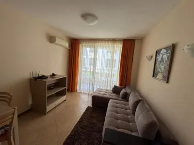 a living room with a couch and a window at VP Royal Sun in Sunny Beach