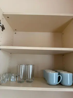 a shelf with bowls and cups on it at VP Royal Sun in Sunny Beach