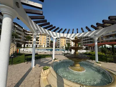 a fountain in the middle of a courtyard with buildings at VP Royal Sun in Sunny Beach
