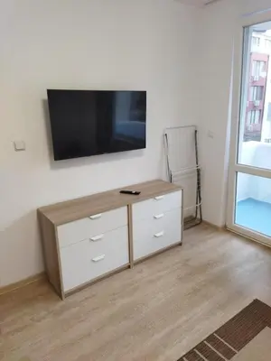 a living room with a tv on a wall at Emona 5 floor 3 in Burgas City