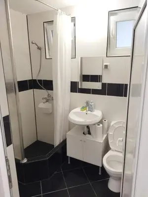 a bathroom with a sink and a toilet and a shower at Emona 5 floor 3 in Burgas City
