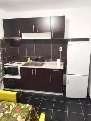 a kitchen with a sink and a white refrigerator at Emona 5 floor 3 in Burgas City