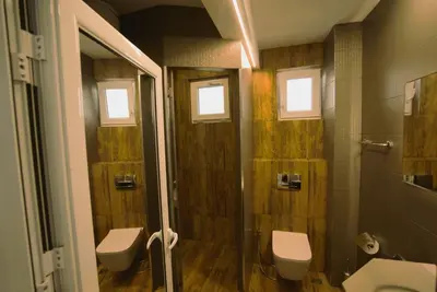 a bathroom with two toilets and a shower at Emona 5 floor 2 in Burgas City