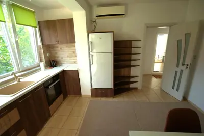 a kitchen with a refrigerator and a sink at Emona 5 floor 2 in Burgas City