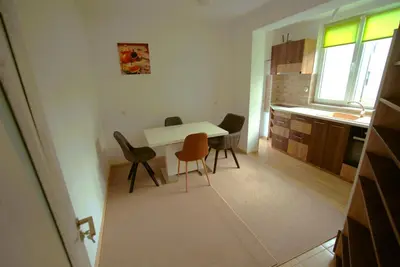 a kitchen with a table and chairs in a room at Emona 5 floor 2 in Burgas City