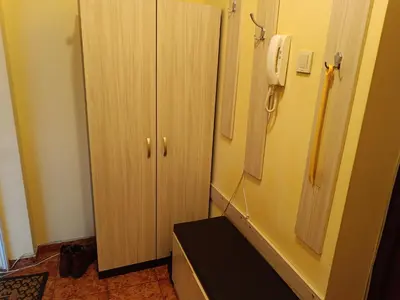 a room with a telephone next to a cabinet at Апартамента на центъра на Варна до фонтаните и морето и градинта in Varna City