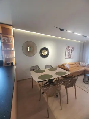 a living room with a table and a couch at Divalla Apartment Burgas in Burgas City