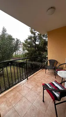 a balcony with two chairs and a table and a fence at Sveti Vlas, Paradise Dreams Apartment in Sveti Vlas
