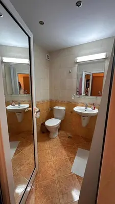 a bathroom with two sinks and a toilet and two mirrors at Sveti Vlas, Paradise Dreams Apartment in Sveti Vlas
