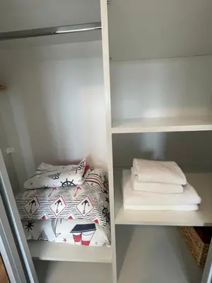 a small room with a bunk bed and towels at Fortuna Cape 4 apartment in Byala