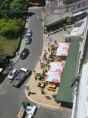 an overhead view of a street with parked cars and tables at Apartament Hotel Miramar Palace in Sunny Beach