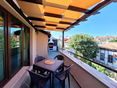 a balcony with a table and chairs on a balcony at Veneto Apartment in Varna City