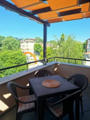 a table and chairs on a balcony with a view at Veneto Apartment in Varna City
