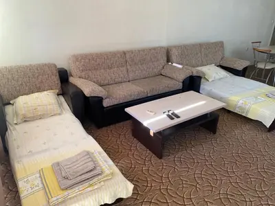 a living room with a couch and a coffee table at Apartments complex Breeze Sunny beach - Апартаменти комплекс Бриз Слънчев бряг in Bŭnzareto