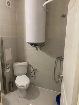a bathroom with a toilet and a water tank at Apartments complex Breeze Sunny beach - Апартаменти комплекс Бриз Слънчев бряг in Bŭnzareto