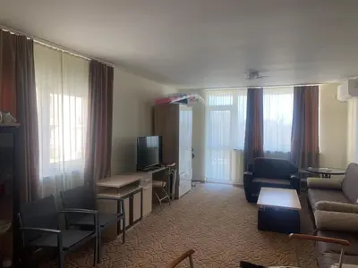 a living room with a couch and a tv at Apartments complex Breeze Sunny beach - Апартаменти комплекс Бриз Слънчев бряг in Bŭnzareto
