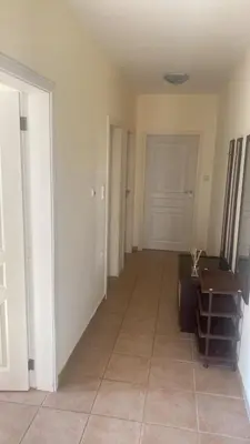 an empty room with a hallway with a door at Apartments complex Breeze Sunny beach - Апартаменти комплекс Бриз Слънчев бряг in Bŭnzareto