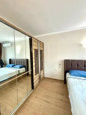 two beds in a room with mirrored walls at Royal Dreams Apartments, Sunny Beach in Sunny Beach