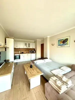 a large bedroom with a large bed and a kitchen at Royal Dreams Apartments, Sunny Beach in Sunny Beach