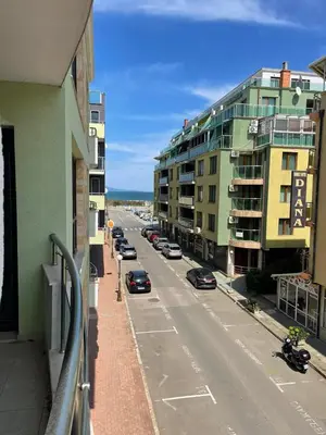 a view of a street with cars parked on the street at Делукс Апартамент Лазур Поморие in Pomorie