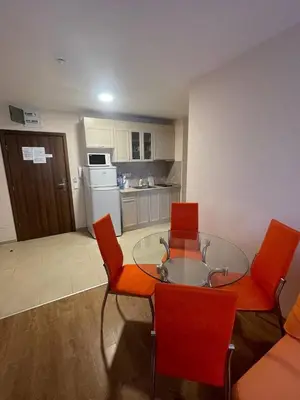 a kitchen with a glass table and red chairs at Premier Fort Beach Hotel ! in Sveti Vlas