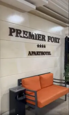 an orange bench sitting in front of a sign at Premier Fort Beach Hotel ! in Sveti Vlas